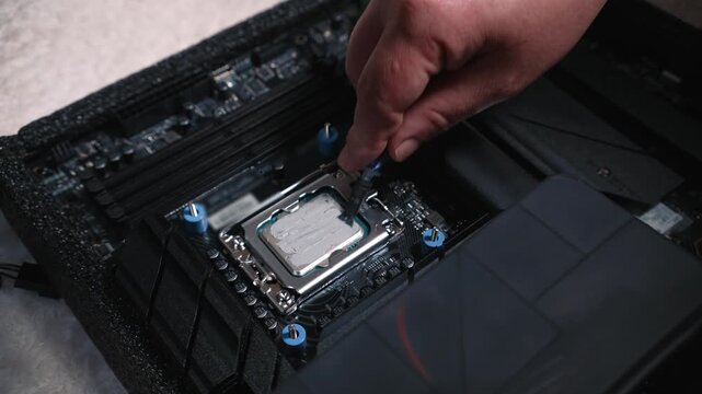 Applying thermal paste on processor before cooling installation, even spreading of thermal paste with a tool on an installed processor during personal computer assembly