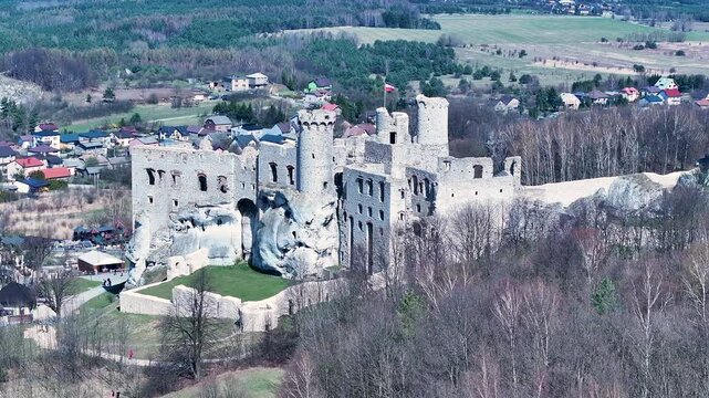 Aerial rural Poland Zamek Ogrodzieniec castle 2. Ruins of medieval castle south Poland. Original stronghold from 11th century, stone castle built in13th century. Rocky mountain top.
