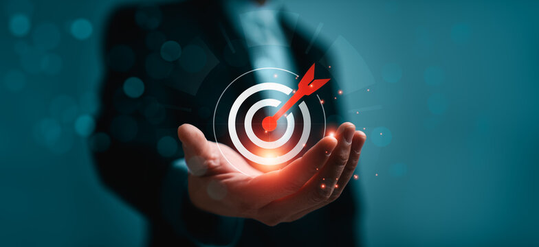 Business goal achievement and strategic target success concept with glowing target icon and arrow in hand, representing precision planning, KPI performance, leadership strategy, successful business