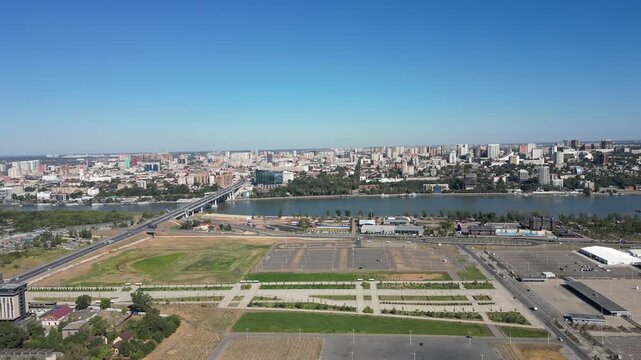 Expansive panoramic view of rostov-on-don, showcasing the cityscape, the don river, and the voroshilovsky bridge under a clear blue sky