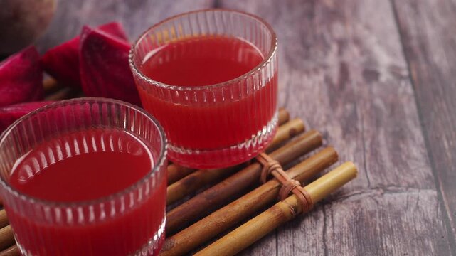 beet root juice served in clear glasses with bamboo mat
