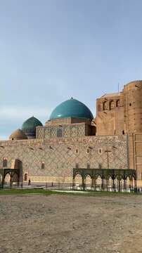 Turkistan, Republic of Kazakhstan - 06.04.2026: Overview of the Khoja Ahmed Yasawi mausoleum. Camera movement from back to facade of the building.