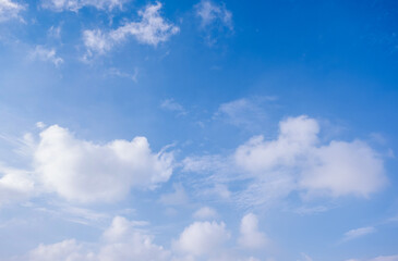 Obraz premium clear blue sky background,clouds with background, Blue sky background with tiny clouds. White fluffy clouds in the blue sky. 