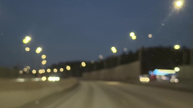 Night driving on a dark highway with blurred taillights, passing cars, and a moody low-light atmosphere captured from inside a moving vehicle. High quality FullHD footage