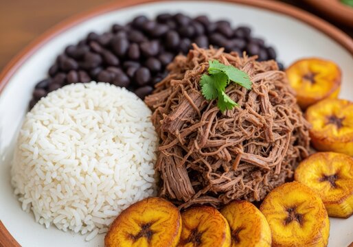 Pabelln criollo, a traditional venezuelan dish with shredded beef, black beans, white rice, and fried plantains