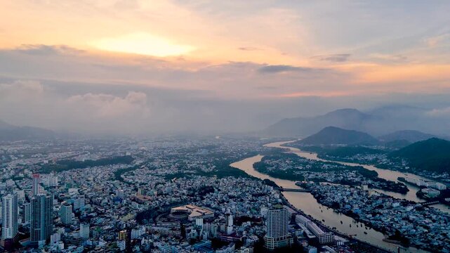 Central district and river with panoramic view of the city from a bird's eye view, evening on the coast of Southeast Asia, evening at sunset, sunset in Nha Trang.