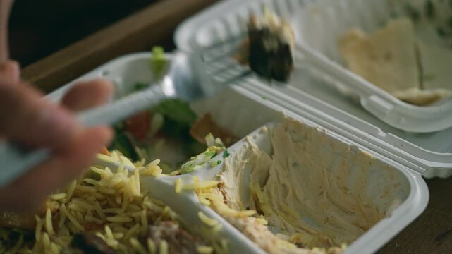 Takeaway meal in a white container - kebab with rice and salad