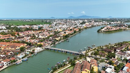 Hoi An (Hoian), Da Nang City (Quang Nam), Vietnam: 4K aerial view of ancient town, UNESCO heritage, Hoai river, boats, lantern streets and historic waterfront. © Thomas