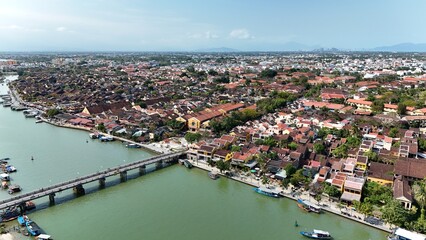 Obraz premium Hoi An (Hoian), Da Nang City (Quang Nam), Vietnam: 4K aerial view of ancient town, UNESCO heritage, Hoai river, boats, lantern streets and historic waterfront.