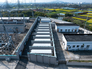 Naklejka premium Aerial view of battery energy storage array at a substation facility in rural area