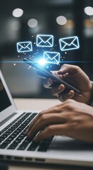 Naklejka premium Hands using laptop and smartphone with glowing email above
