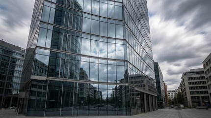 Obraz premium Urban glass building reflecting sky and moving clouds