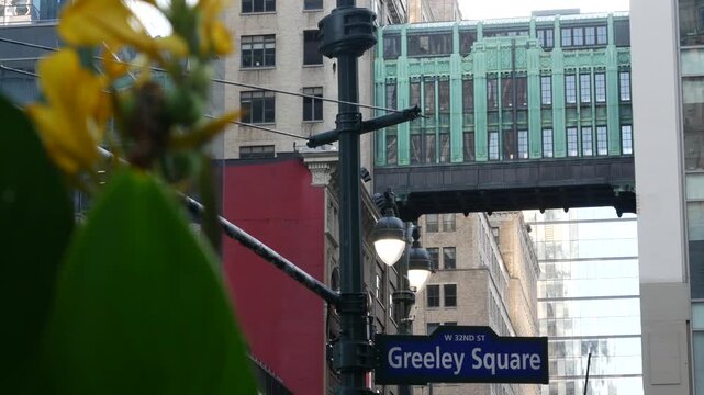 New York City Gimbels bridge, Manhattan Midtown, United States of America. Skybridge on Broadway, Herald Square, USA. Gimbels traverse on 6 avenue. Historic elevated walkway 1925. Greeley Square sign.