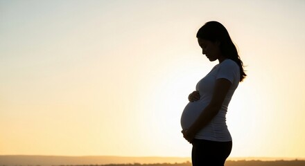Fototapeta premium Minimalist Silhouette of Pregnant Woman Practicing Gentle Yoga at Sunrise