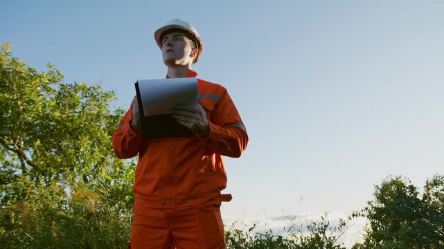 Environmental Engineer Inspecting Sustainable Construction Site on Mountain Peak