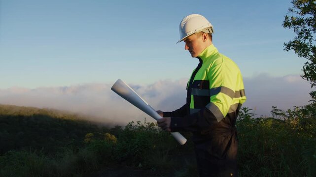 Environmental Engineer Inspecting Sustainable Construction Site on Mountain Peak