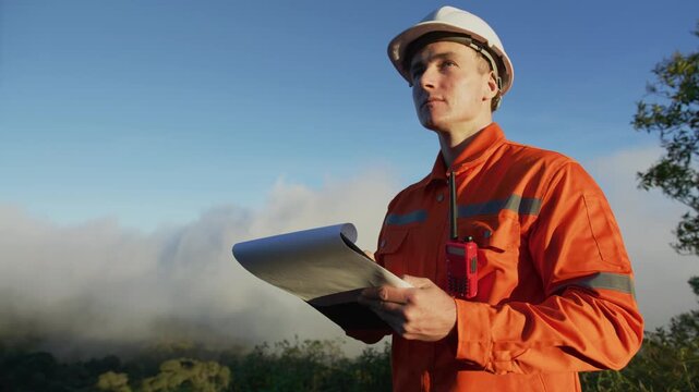 Environmental Engineer Inspecting Sustainable Construction Site on Mountain Peak