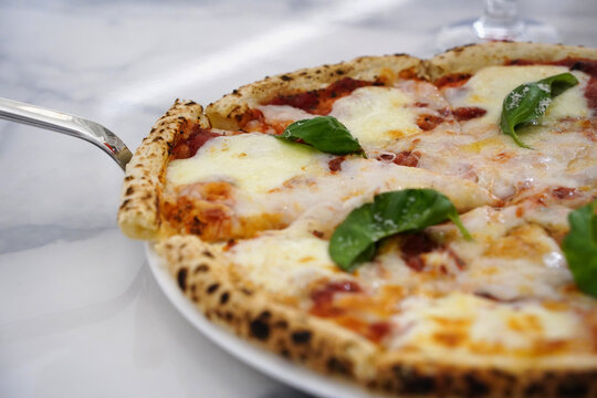 Delicious Hot Margherita Pizza on White Plate with Marble Background