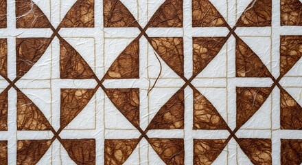 Fototapeta premium Close-up of an intricate geometric pattern crafted from organic, fibrous material in earthy brown and cream tones, creating a visually rich and textured abstract background