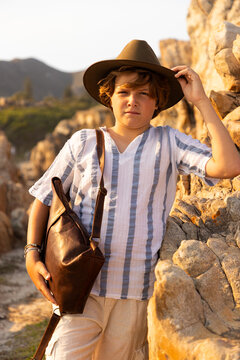 12 year old boy exploring rocky coastline of Hermanus, South Africa