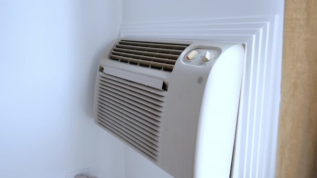 Wall mounted air conditioner. HVAC climate control system inside residential interior.