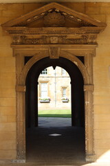 Fototapeta premium View through an archway into an Oxford college garden