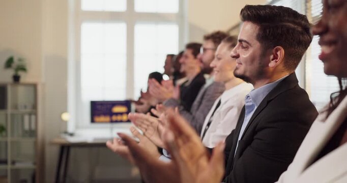 Business team colleagues give applause in office. Side view of clapping hands during meeting, recognizing a presentation milestone and team success. Strong concept of support and unity.