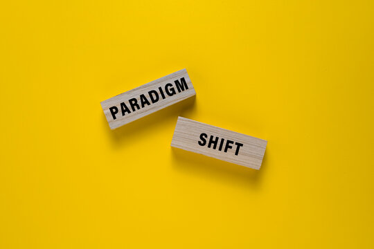 paradigm shift words on wooden blocks. isolated on yellow background