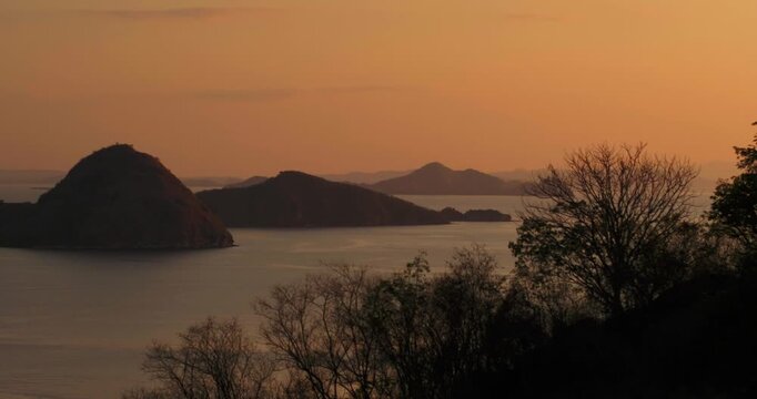 Aerial sunset over tropical islands and ocean in Labuan Bajo