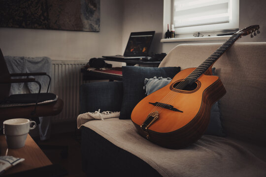 Gypsy jazz acoustic guitar on bed at home