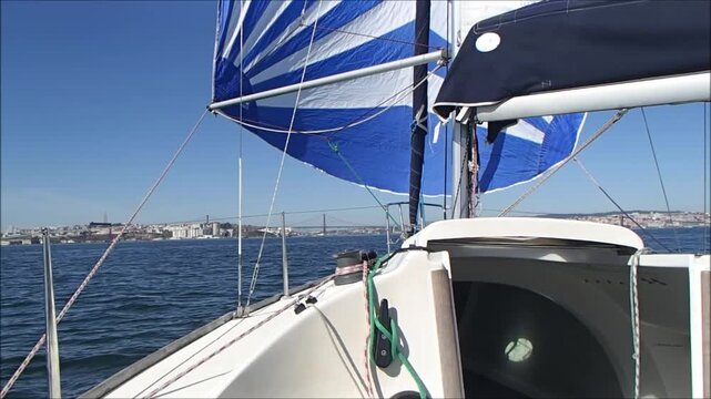 Sailing under a clear blue sky with vibrant flags waving