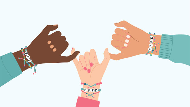 Three diverse friends making a pinky promise together while wearing colorful friendship bracelets with letter beads on white.