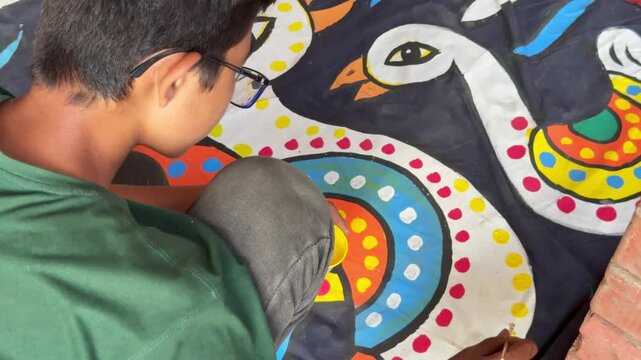 Young Bangladeshi Artist Painting Traditional Alpana Design for Pohela Boishakh in Dhaka, Bangladesh on 14 April, 2025