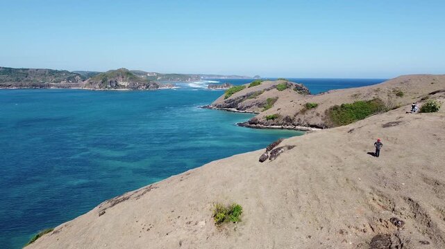 Aerial drone view of the rugged coastline and turquoise ocean in South Lombok, Indonesia