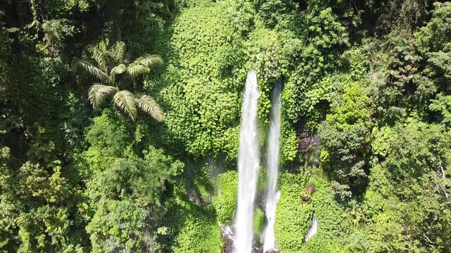 Cinematic flyover of the powerful Sendang Gile falls and lush jungle, Lombok Indonesia