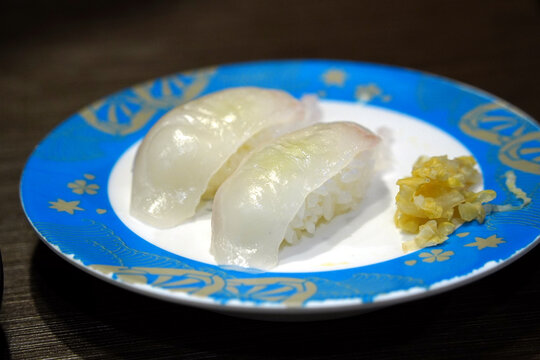 Delicious Japanese white fish sushi close-up, Flounder Nigiri in a sushi bar.