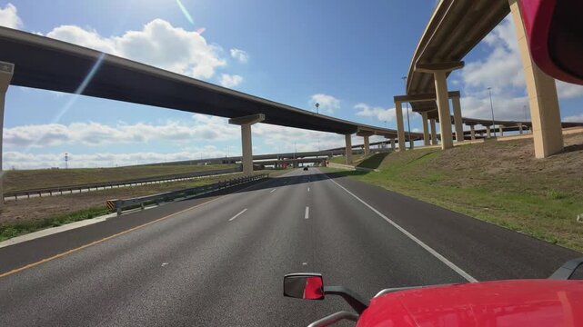 Big rig truck POV navigating a complex modern freeway interchange network