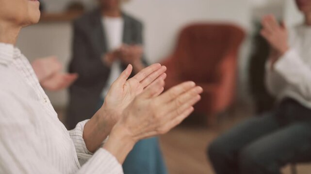Meeting in women club, ladies applauding and cheering, closeup view of hands. Women community for communication and supporting, alcoholic anonymous, group therapy for victims of domestic violence