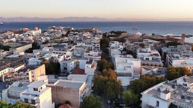 Golden hour aerial view of Rodos city and Aegean Sea coastline