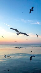 Fototapeta premium A serene coastal scene captures a flock of seagulls soaring gracefully against a vibrant sunset sky over calm ocean waters.