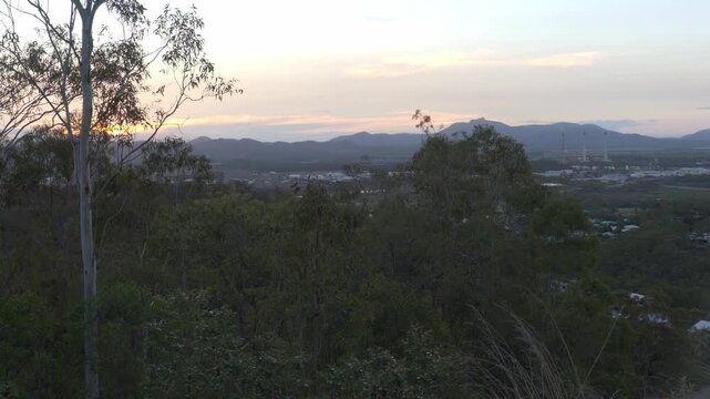 Gladstone Australian power station smoke stacks and mountains at sunset 4k