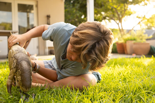 12 year old boy playing with toys in back yard