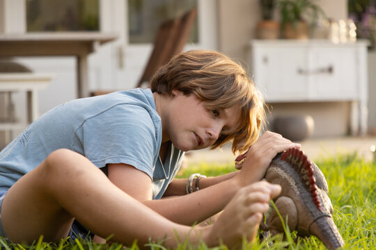 12 year old boy playing with toys in back yard