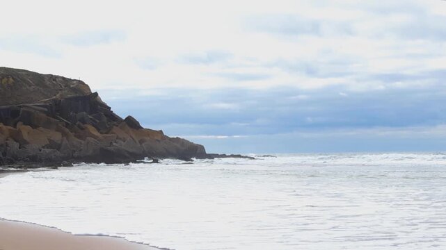 Scenic Ocean Waves Crashing on Praia das Macas Sandy Beach
