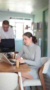 Young businessman of a large company, scolds his employee girl sitting at workdesk in the office. High quality 4k footage