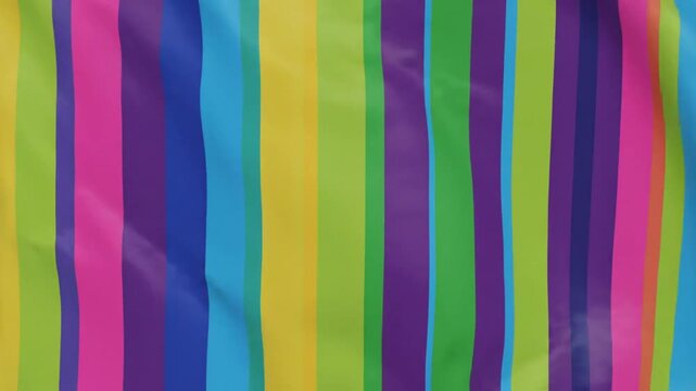 Colorful vertical striped fabric waving in the wind creating a vibrant abstract pattern background