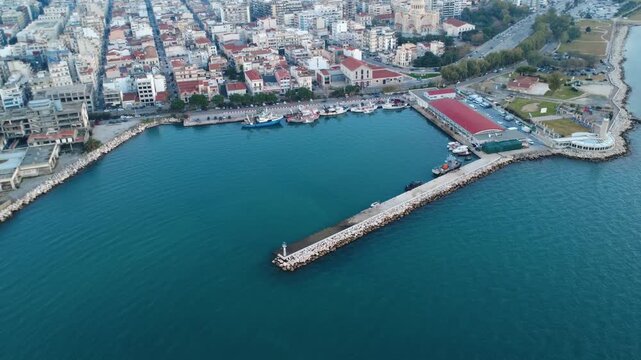 Aerial rotating pier with fishing boats, fish factory and turquoise sea