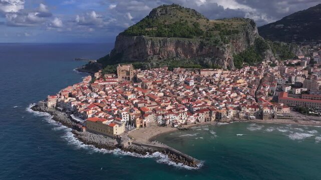 Cefalu, Sicily, aerial drone video. Cefalu beach, cathedral and archeological park, Beautiful Coastal City in Italy.