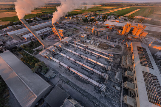 Industrial cement plant with smokestacks from above