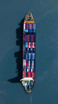 Container ship navigates busy trade route amid logistics crisis and cargo backlog